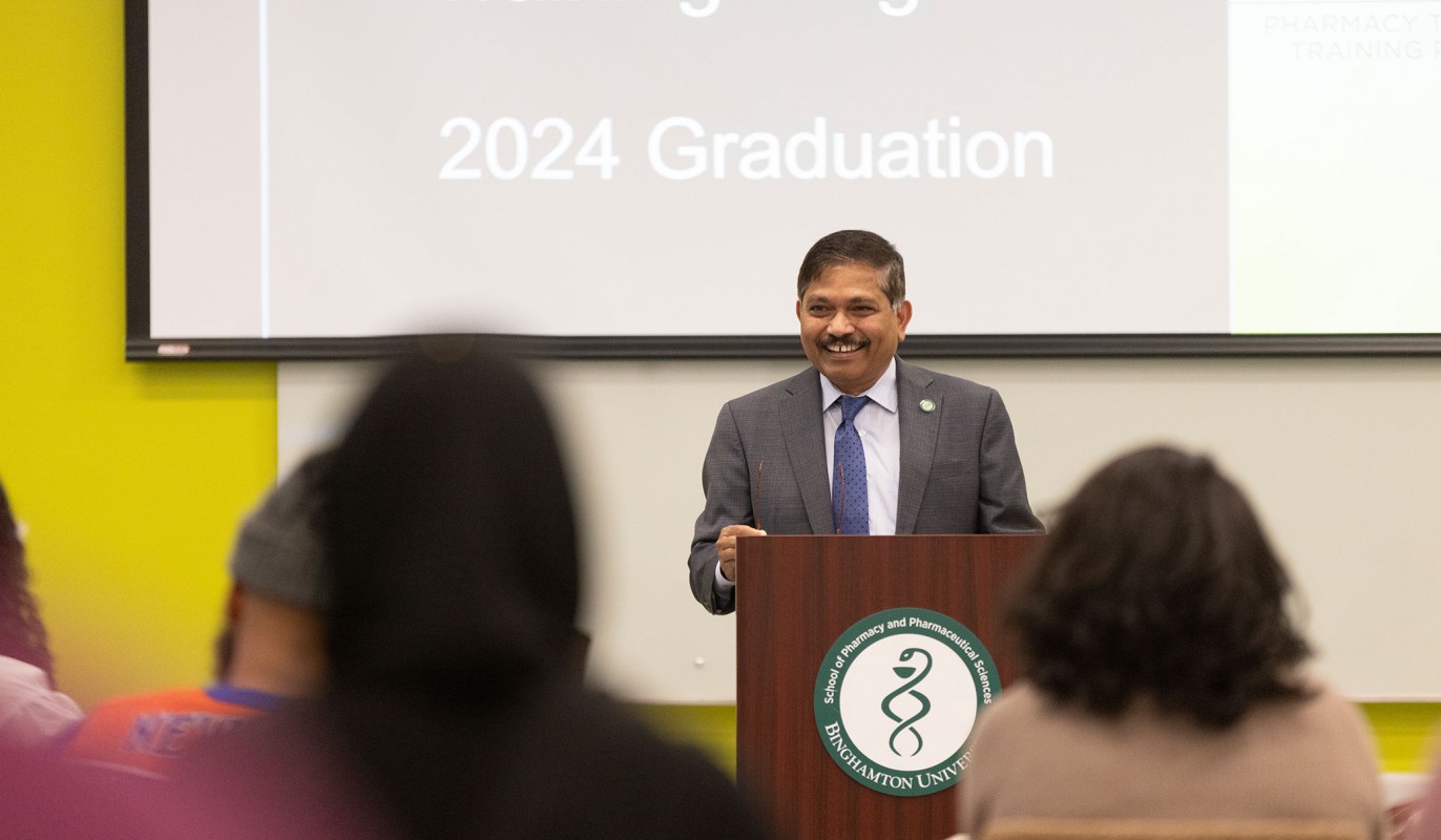 Dean Kanneboyina Nagaraju smiles as he asks the graduates to stand to be recognized before they receive the certificates of completion.