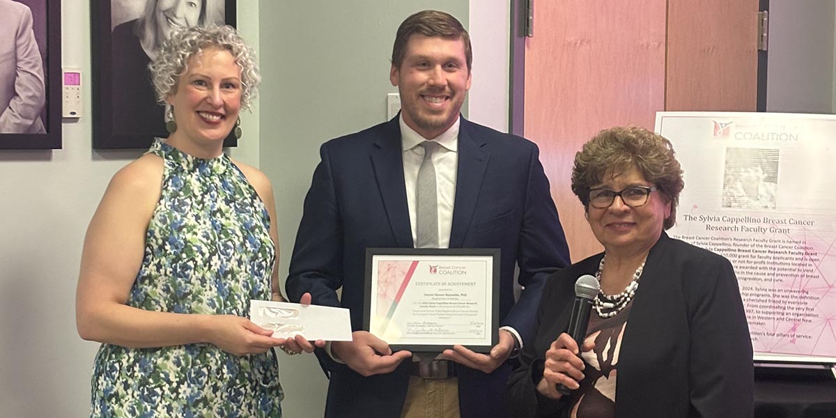 Assistant Professor Daniel S. Reynolds won the Breast Cancer Coalition's Sylvia Cappellino Breast Cancer Research Faculty Grant. Seen here with him at the awards ceremony are Executive Director
Christina Thompson, left, and Research Administrator Silvia Gambacorta-Hoffman.