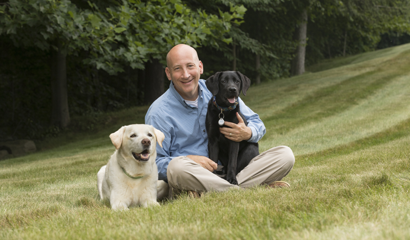 Dr. Jody Sandler '83 sits with Kermit, left, and Shiloh.