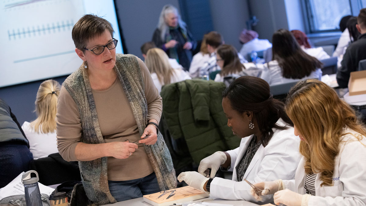 Decker faculty members Tamara Burger (front) and Kathleen Anderson were on-hand during the suturing practice session to help students learn proper technique.