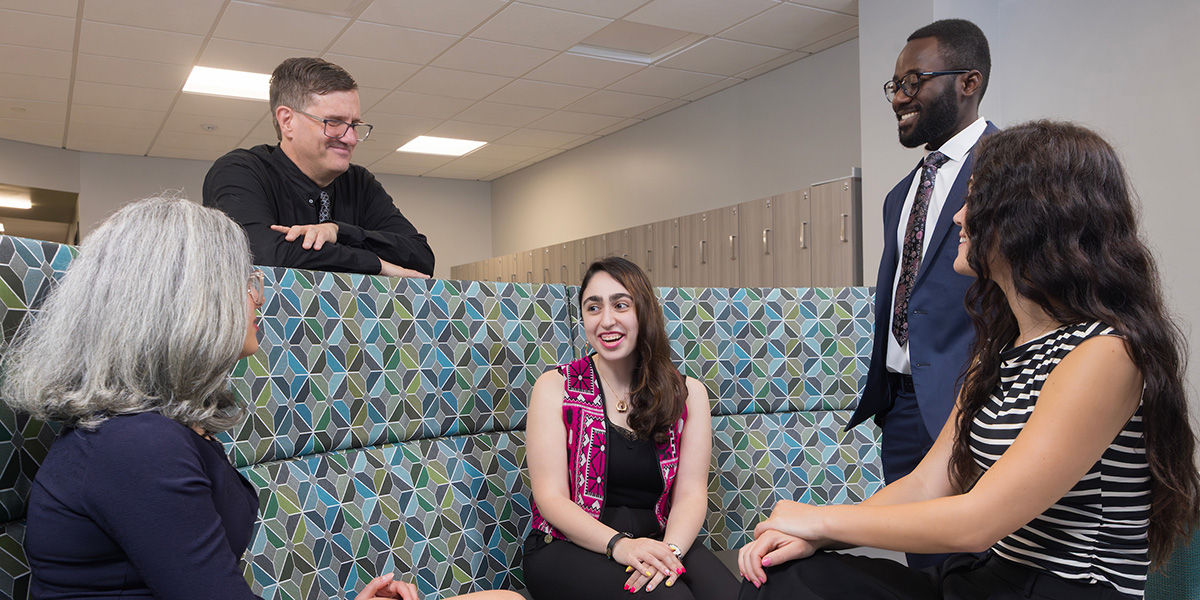 Rodney Gabel, standing on left, meets with SLP graduate students (from left) Ladan Khoshbin, Kiana Tanghatar, Emmanuel Kwaku Addo and Mallory Beard. Tanghatar recently won a Digital Scholarship and Communications Fellowship award.