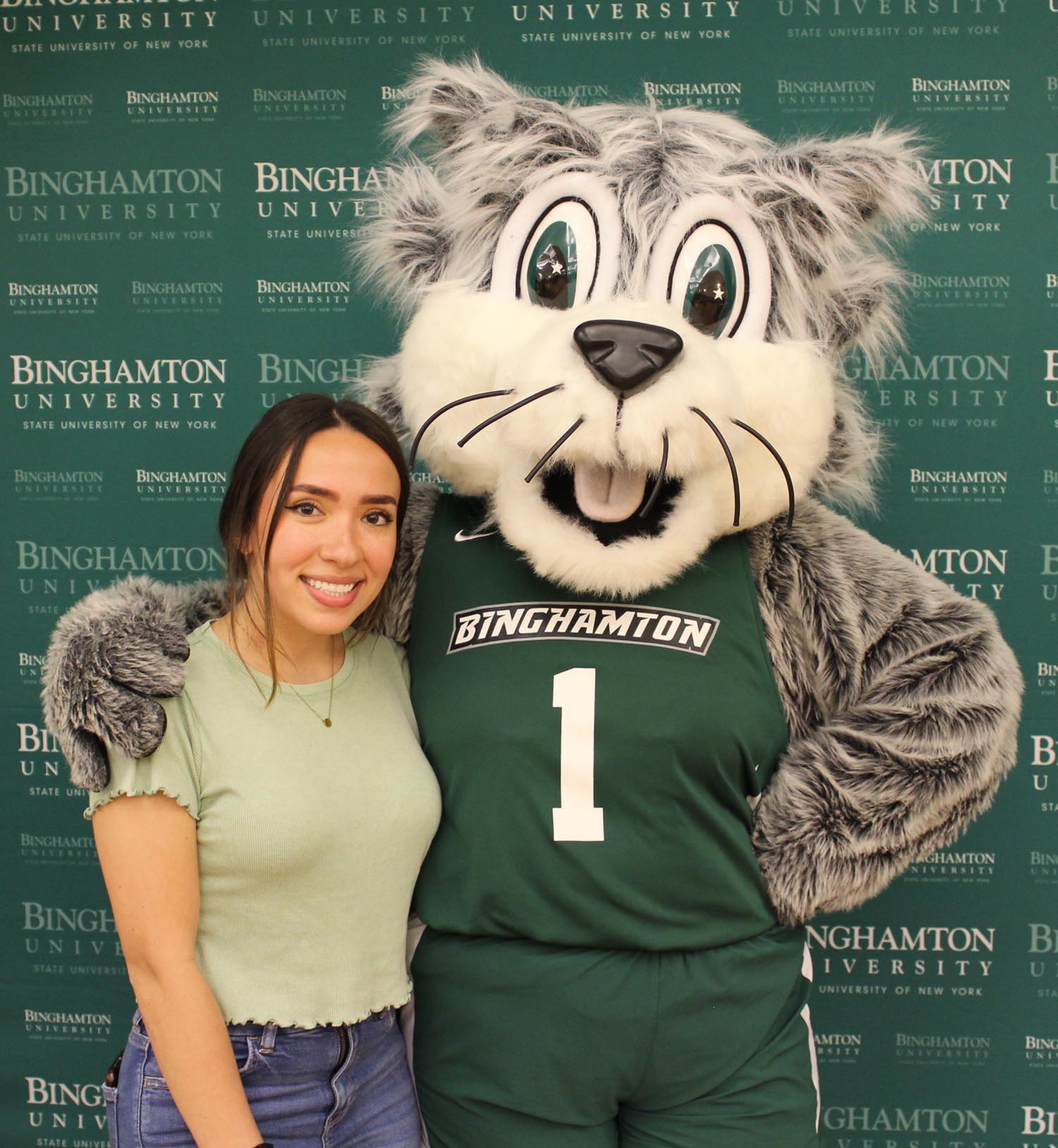 Vanessa Serna Villa hangs out with Baxter the Bearcat at the Watson Career and Alumni Connections graduation celebration in May 2022.