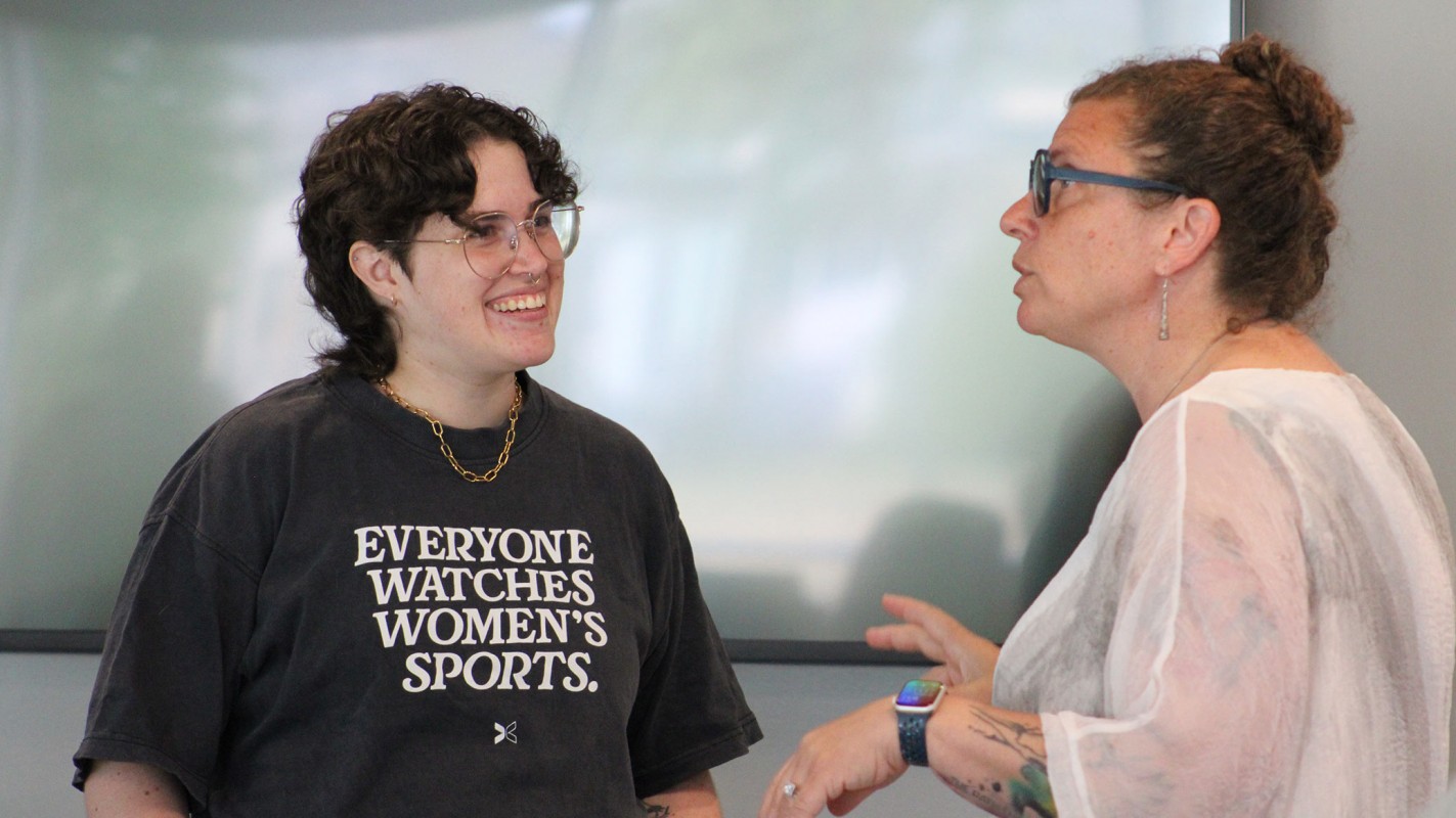 Christianna Friedrichsen (left), the associate director of admissions, speaks with Tracy Brooks (right), the chair and associate professor of pharmaceutical sciences, during the wellness workshop.