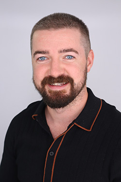 A male human being smiling