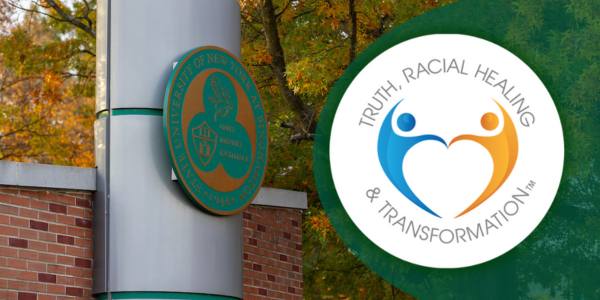 Binghamton University entrance sign with a fall foliage background and the truth, racial healing and transformation campus logo