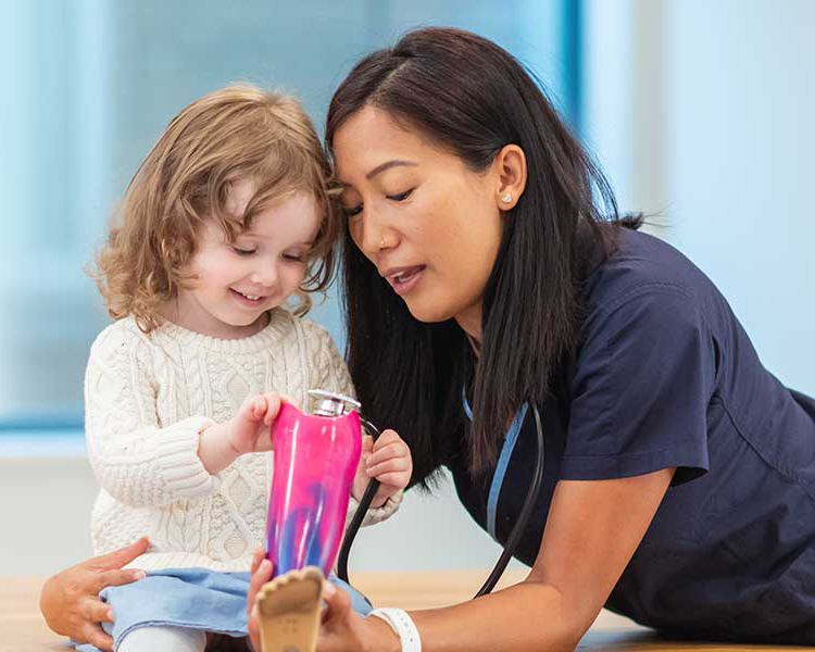 A Binghamton University alum working with a child in the occupational therapy field. photo