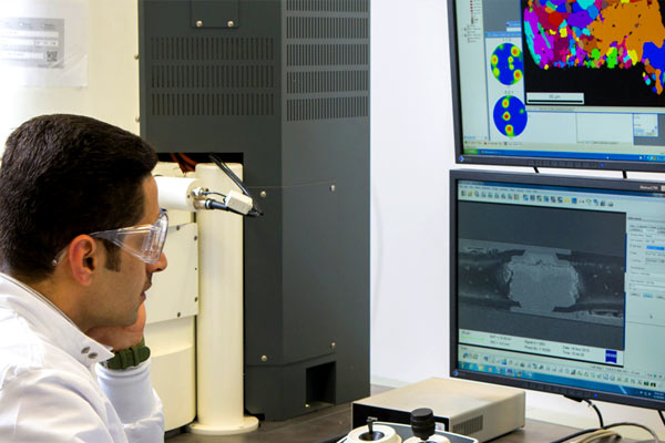 A Physics Department Faculty member looks over imagery for research on his computer.  photo