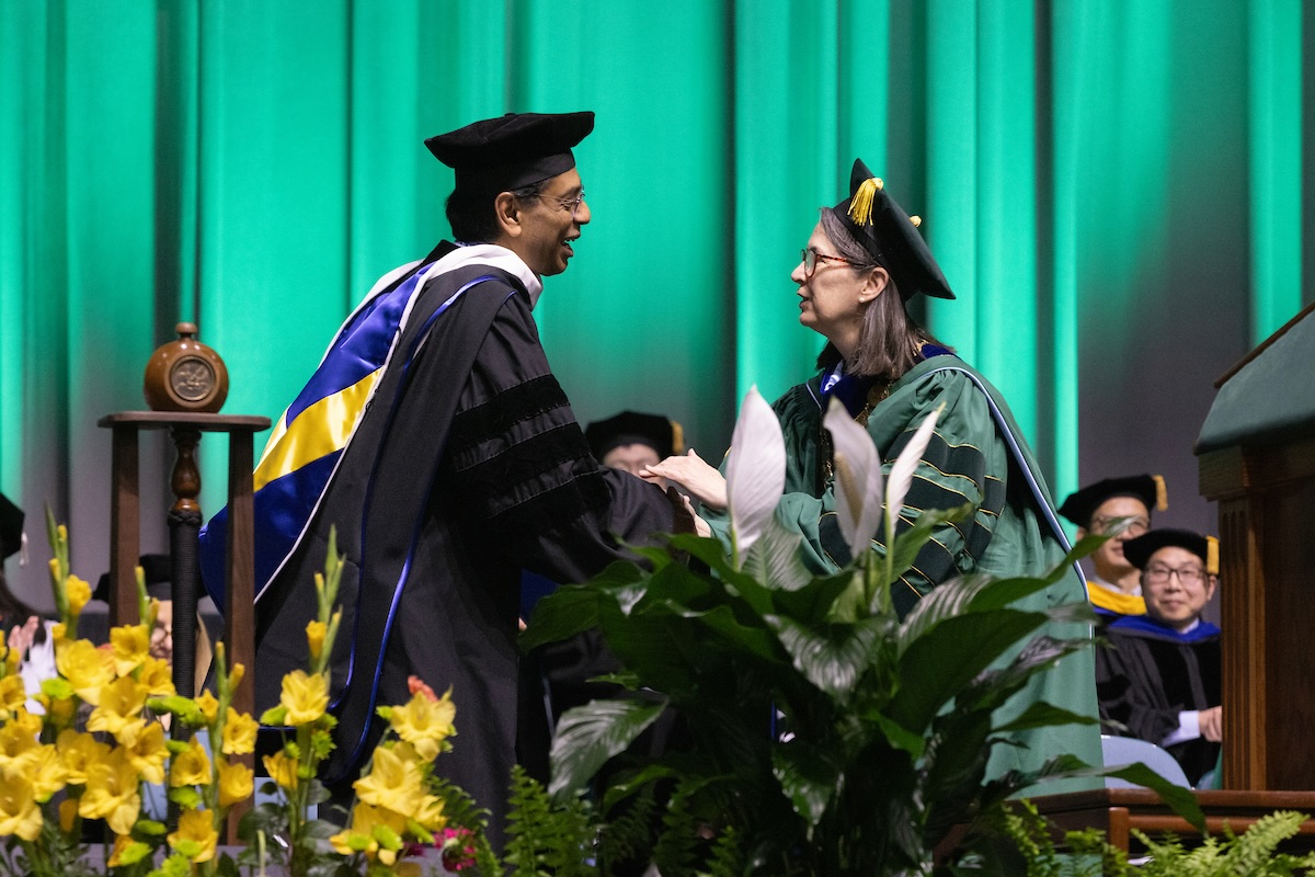 President D'Alleva (right) shakes hands with honorary degree recipient Nana Banerjee. President D'Alleva (right) shakes hands with honorary degree recipient Nana Banerjee.