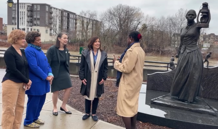 President D'Alleva and other leaders from the University welcome Governor Hochul to the Harriet Tubman statue outside of the University Downtown Center.