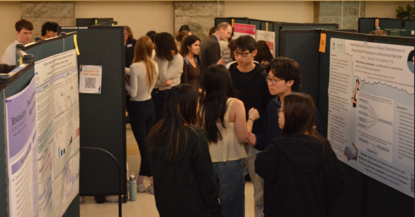 looking down crowded aisle of students and posters
