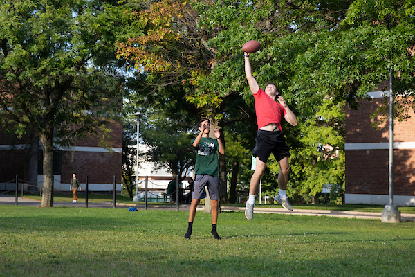 Students playing co-rec football on Hinman's field.