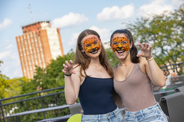 Two female, Hinman students with tiger face painting.