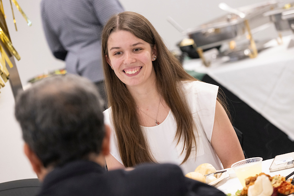 Student at a dinner with a faculty member in Hinman's dining hall.
