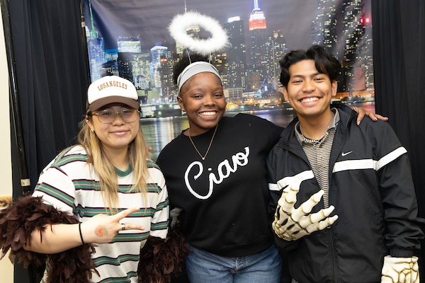 3 students posing posing and smiling.