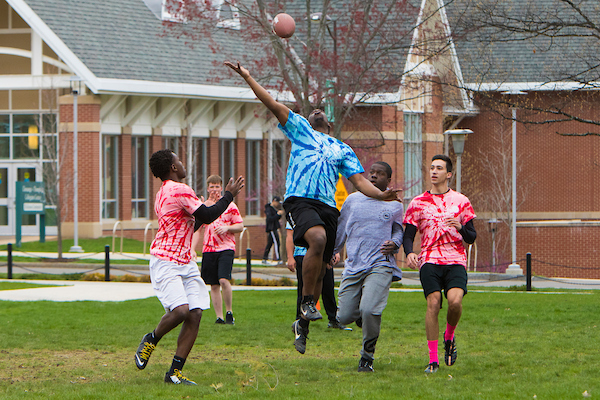 Students playing football during Newing Navy.