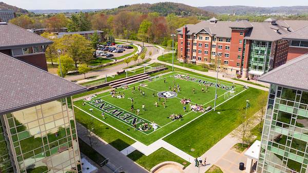 Aerial view of students playing games on Newing's turf field.