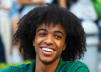 Binghamton University student smiling outdoors on campus.